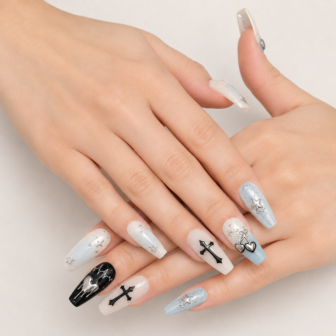 Close view of two hands wearing Mint Nocturne Long Coffin mint black and silver press-on nails