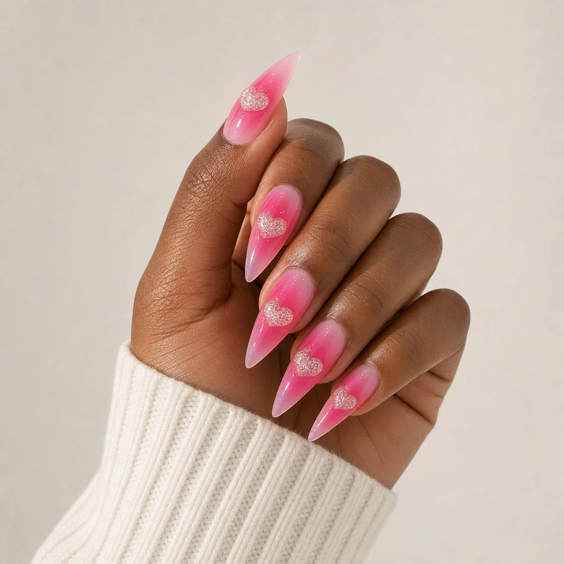 Neon Heartbeat pink jelly heart manicure on one medium-brown hand