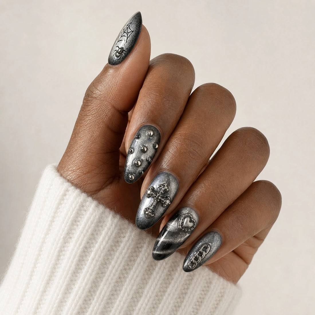 Silver Seance black silver gothic manicure on one medium-brown hand