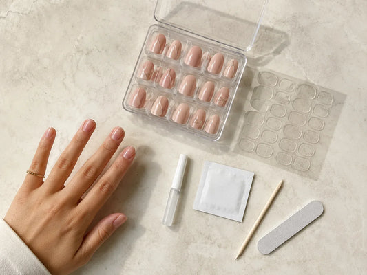 Press-on nail kit with adhesive tabs, nail glue, prep pad, file, and reusable nails