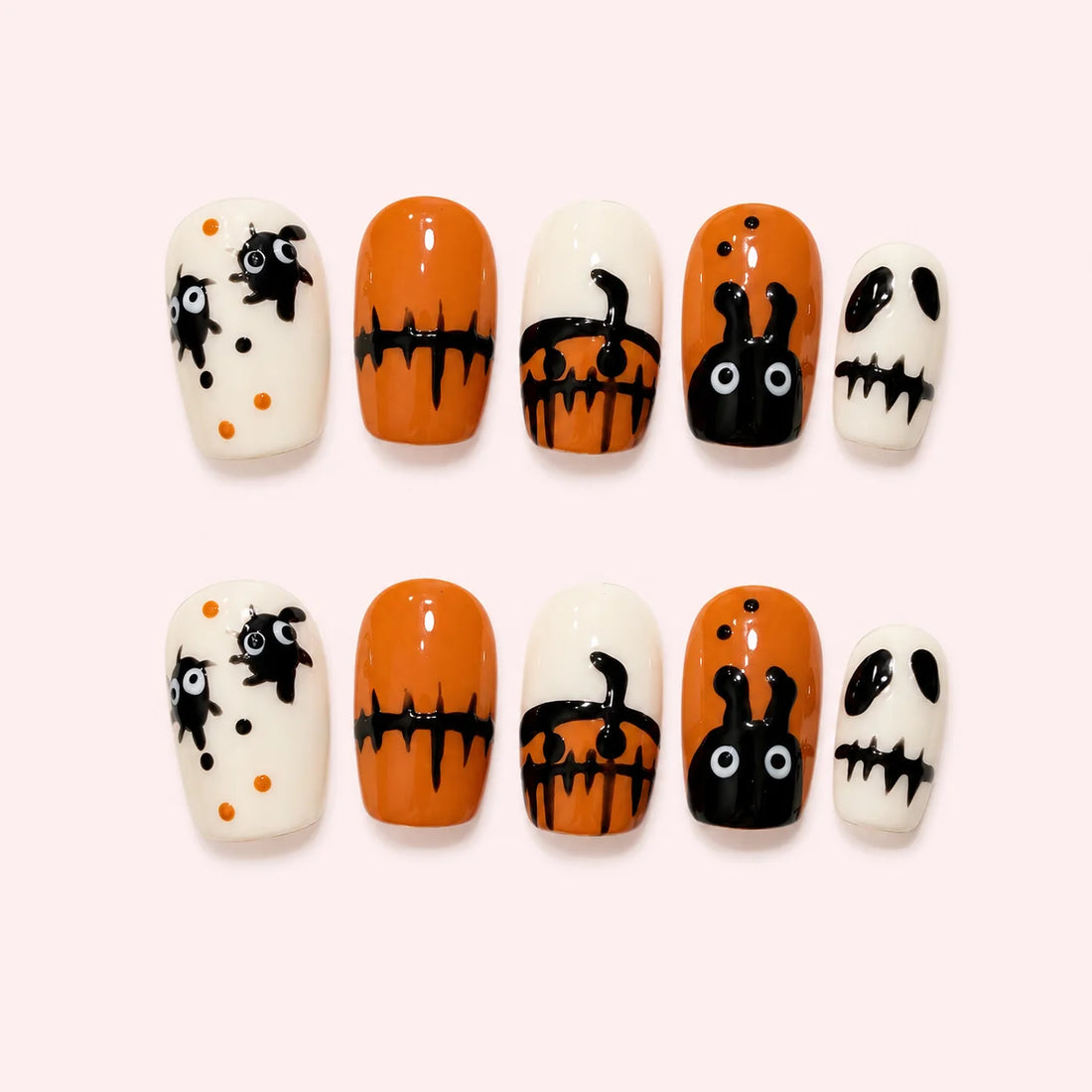 Trickster Parade orange, cream and black nails with playful Halloween characters