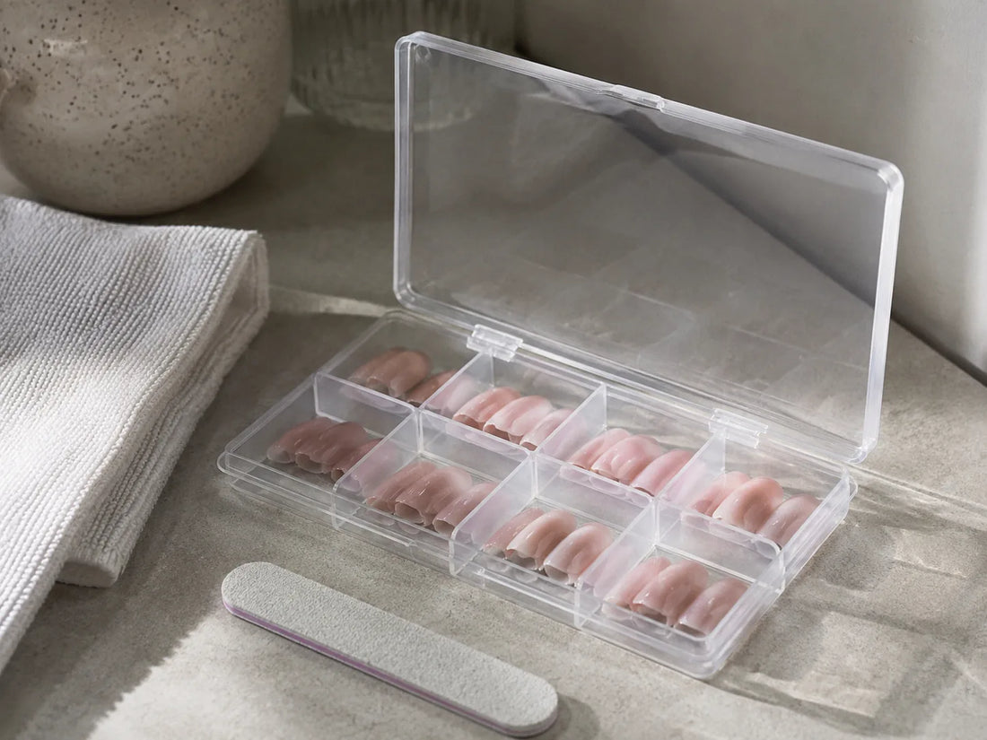 Reusable press-on nails stored neatly in a clear plastic nail organizer