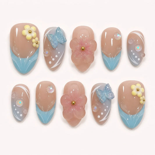 Poolside Alchemy medium almond aqua press-on nails with 3D flowers, butterflies and bubbles