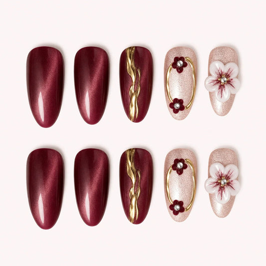 Gilded Merlot medium almond burgundy cat-eye press-on nails with gold lines and white flowers