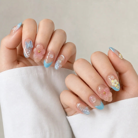 Poolside Alchemy floral aqua press-on manicure on two softly curled hands