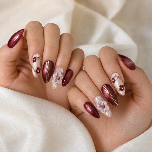 Gilded Merlot floral press-on manicure on two softly curled hands