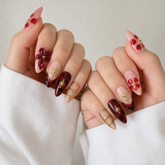 Crimson Keepsake romantic burgundy manicure on two softly curled hands