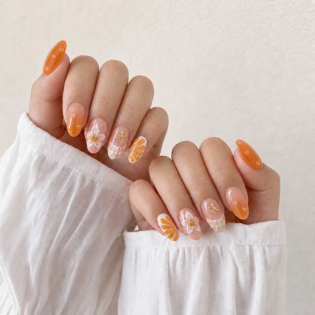 Apricot Reef medium almond press-on nails displayed on two hands