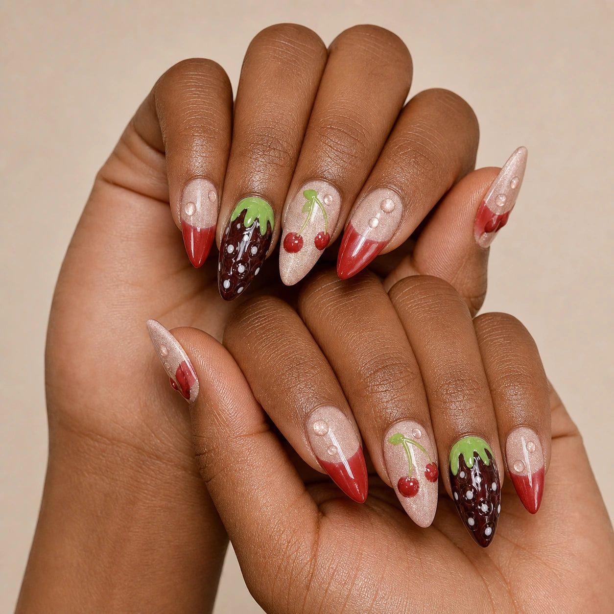 Berry Ganache red fruit manicure on two medium-brown hands