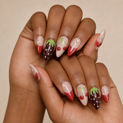 Berry Ganache red fruit manicure on two medium-brown hands