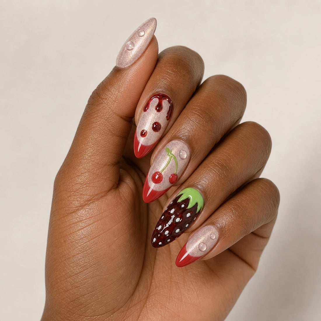 Berry Ganache fruit manicure on one medium-brown hand