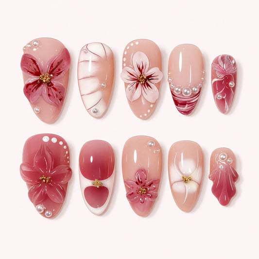 Berry Sonata medium almond pink floral press-on nails on a pale blush background