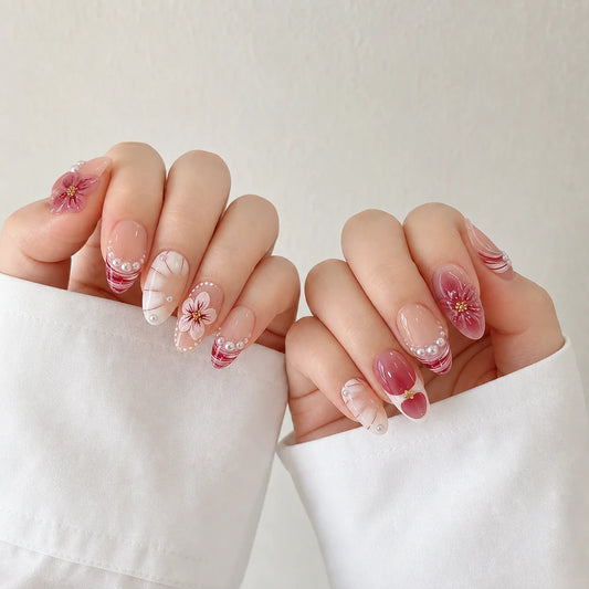 Berry Sonata pink 3D flower press-on manicure on two curled hands