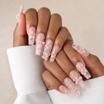 Blossom Sonata blush crystal manicure on two medium-brown hands