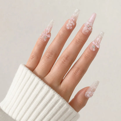 Blossom Sonata crystal tip long coffin nails on one open light-skinned hand