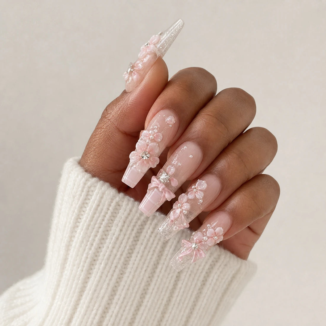 Blossom Sonata blush floral manicure on one medium-brown hand