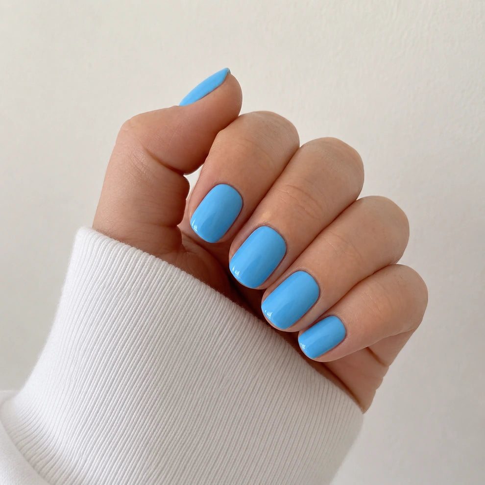 Bluebell Glaze short square blue press-on nails in a front hand view