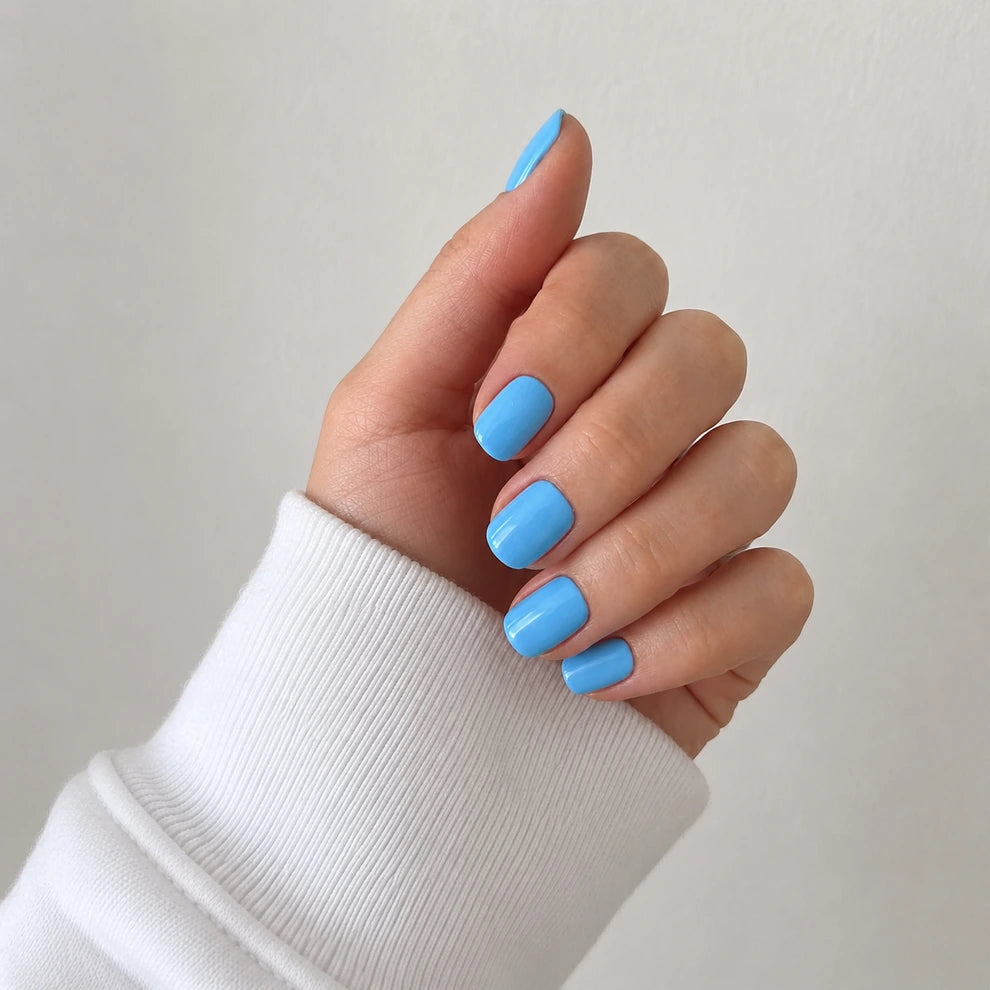 Bluebell Glaze short square blue press-on nails shown from a soft side angle