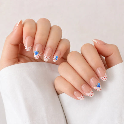 Blueberry Polka manicure on two softly curled hands