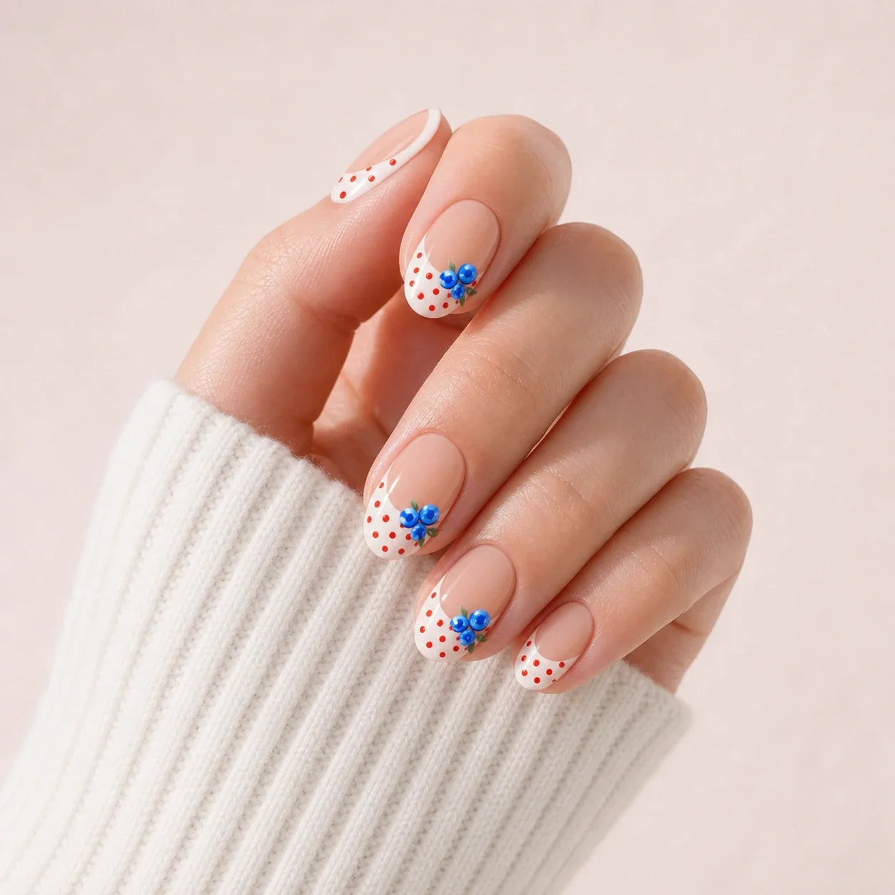 Blueberry Polka French press-on manicure on one curled hand