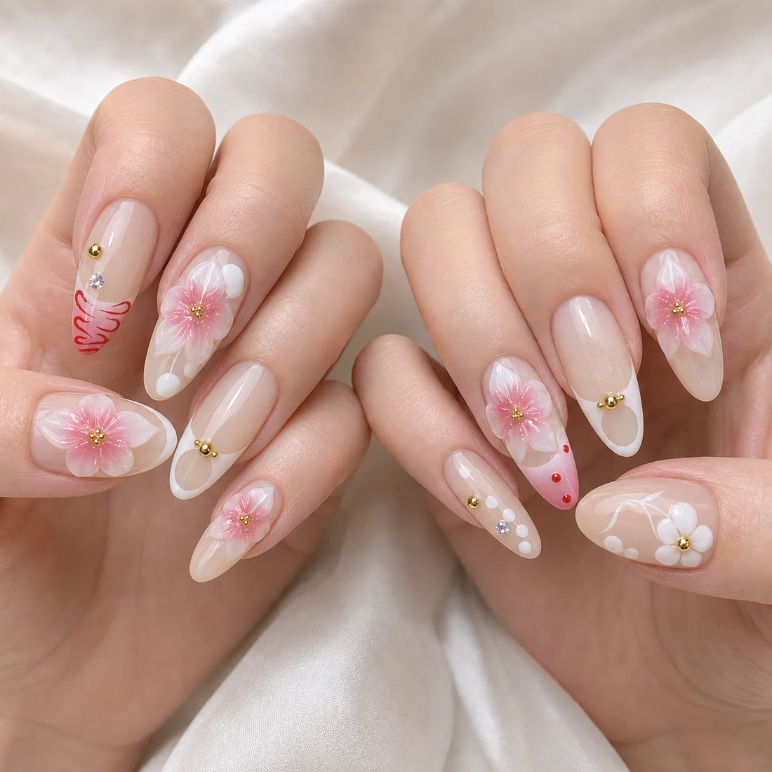 Blush Floralia medium almond floral press-on nails on two softly curled hands, new option