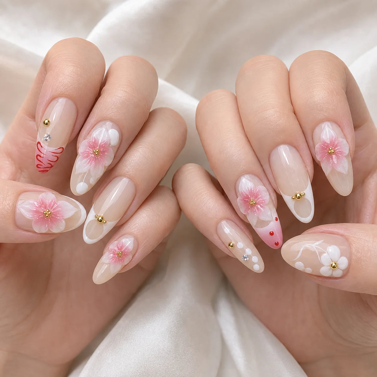 Blush Floralia medium almond floral press-on nails on two softly curled hands, new option