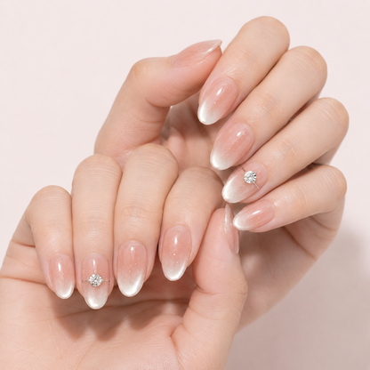 Close view of two light-skin hands wearing Blush Solitaire press-on nails with crystal accents