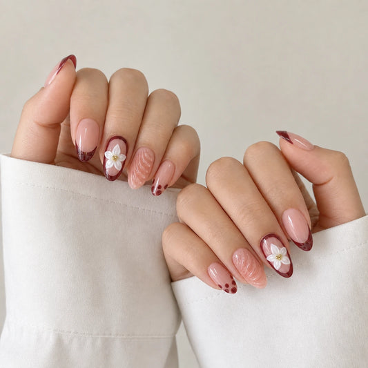 Cassis Corsage floral manicure on two softly curled hands