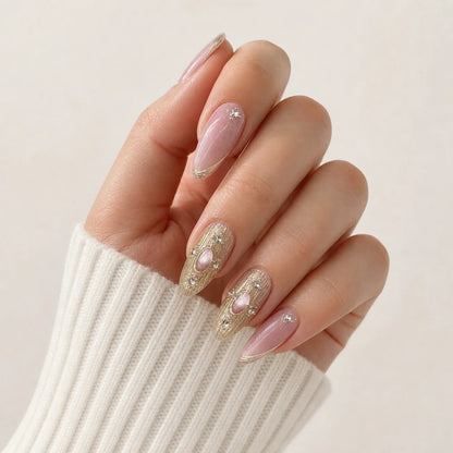 Champagne Oracle cabochon press-on manicure on one softly curled hand