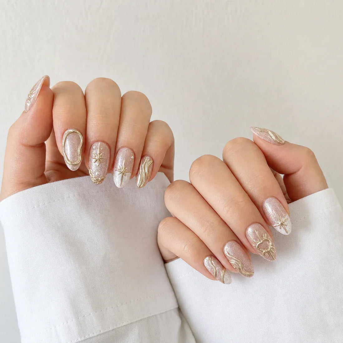 Champagne Zodiac champagne pink press-on manicure on two curled hands