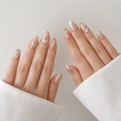 Champagne Zodiac gold celestial almond false nails on two open hands