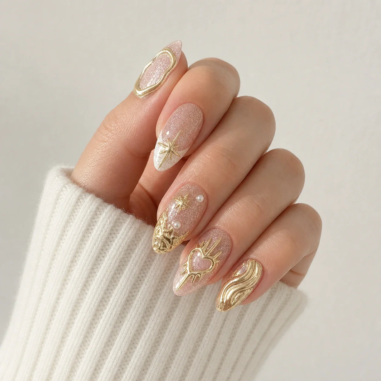 Champagne Zodiac gold chrome manicure on one curled hand