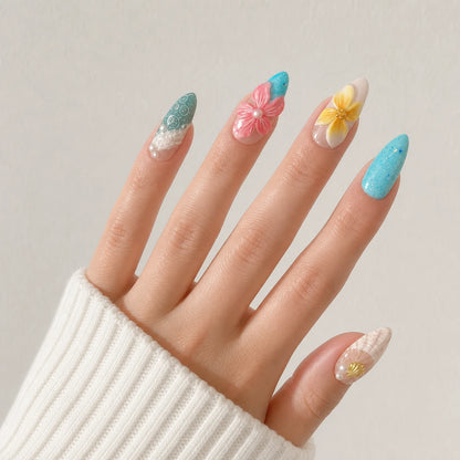 Coral Cabana turquoise tropical nails on one open light-skinned hand