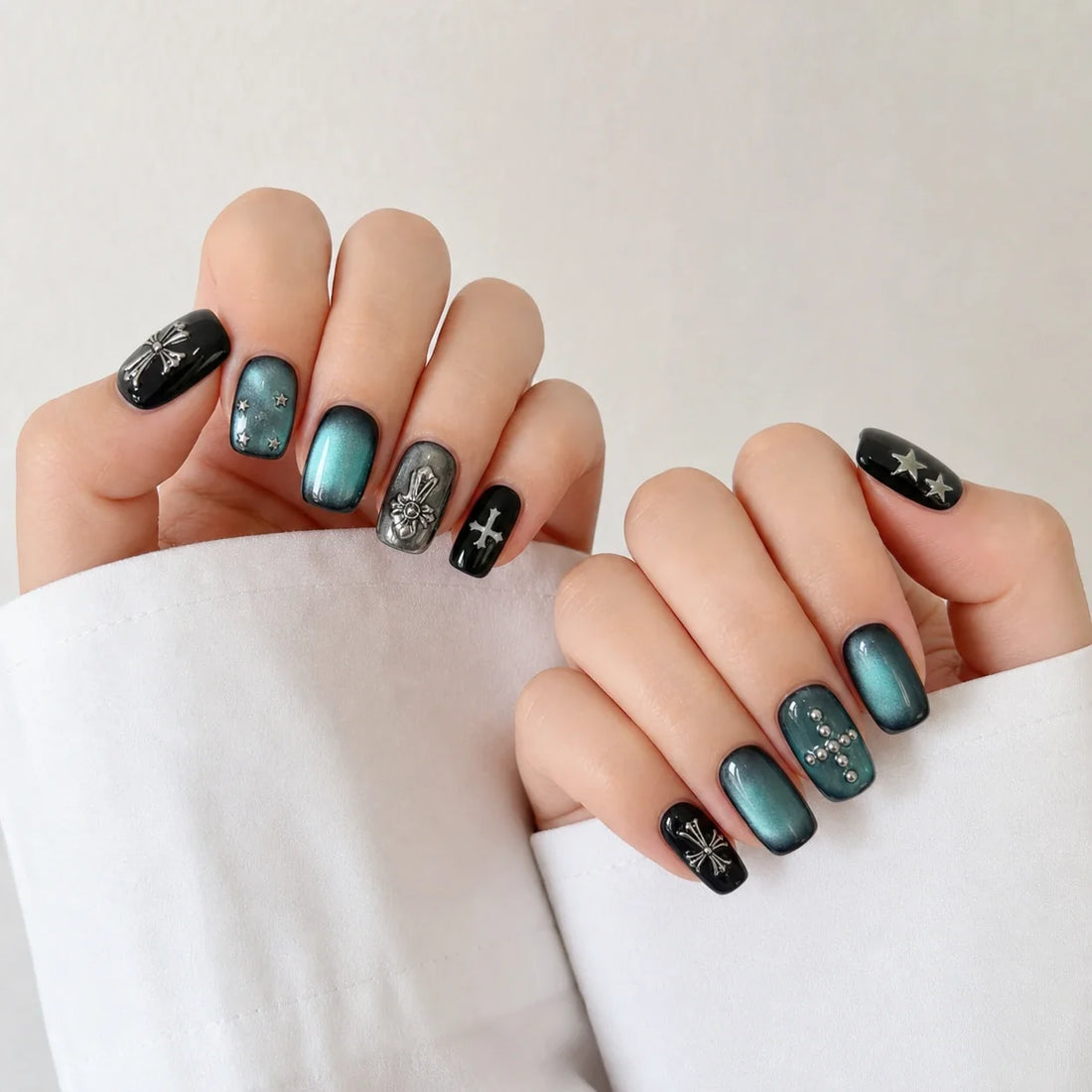 Cross Current cat eye manicure on two softly curled hands