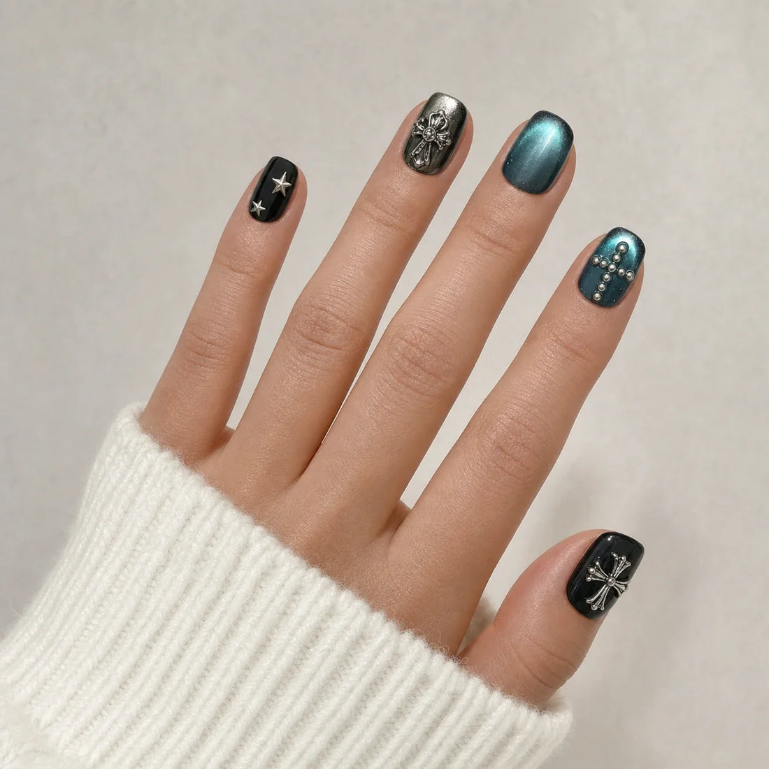 Cross Current gothic star nails on one open hand