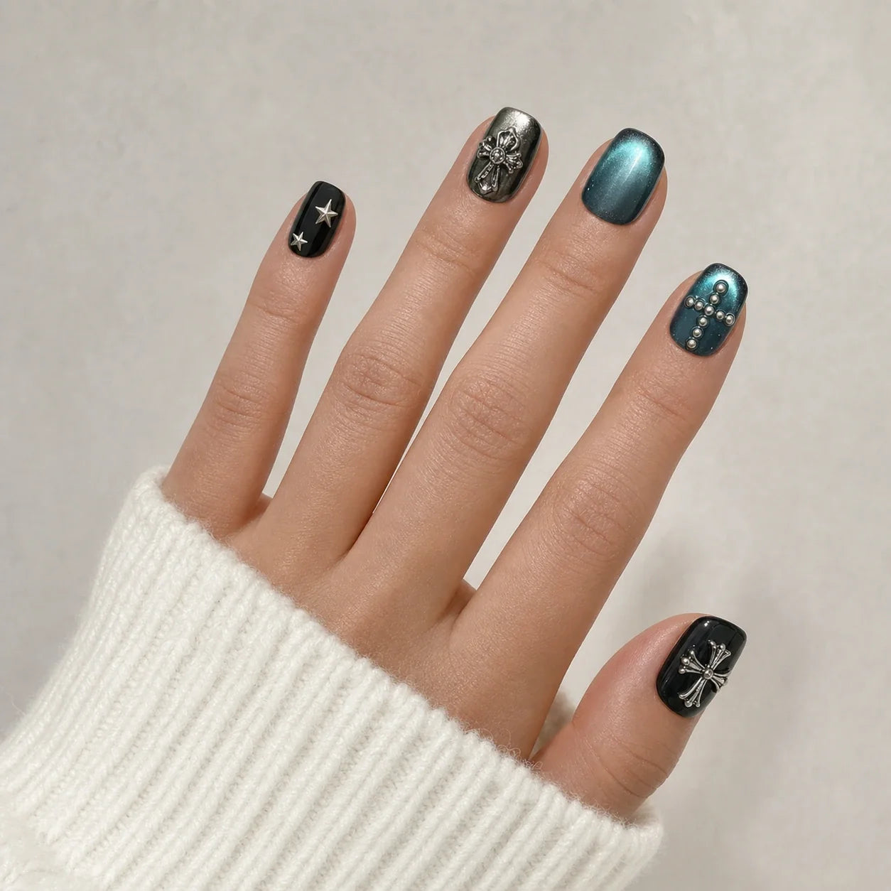 Cross Current gothic star nails on one open hand