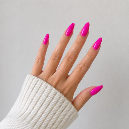 Dragonfruit Crush medium almond hot pink press-on nails shown on an open hand
