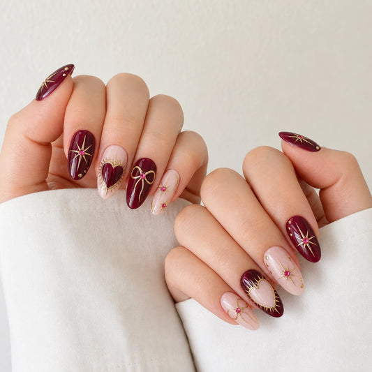 Garnet Wish burgundy and blush oval manicure on two curled light-skinned hands