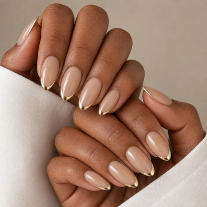Gilded Whisper nude and gold manicure on two medium-brown hands