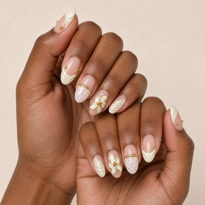 Ivory Brocade ivory gold manicure on two medium-brown hands