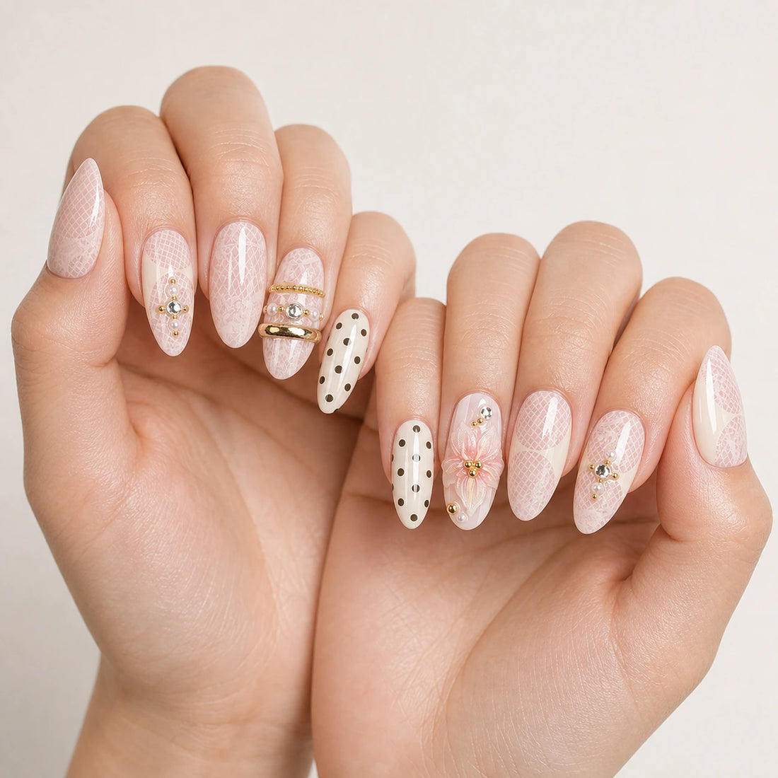 Lace Confetti pink lace manicure on two softly curled hands