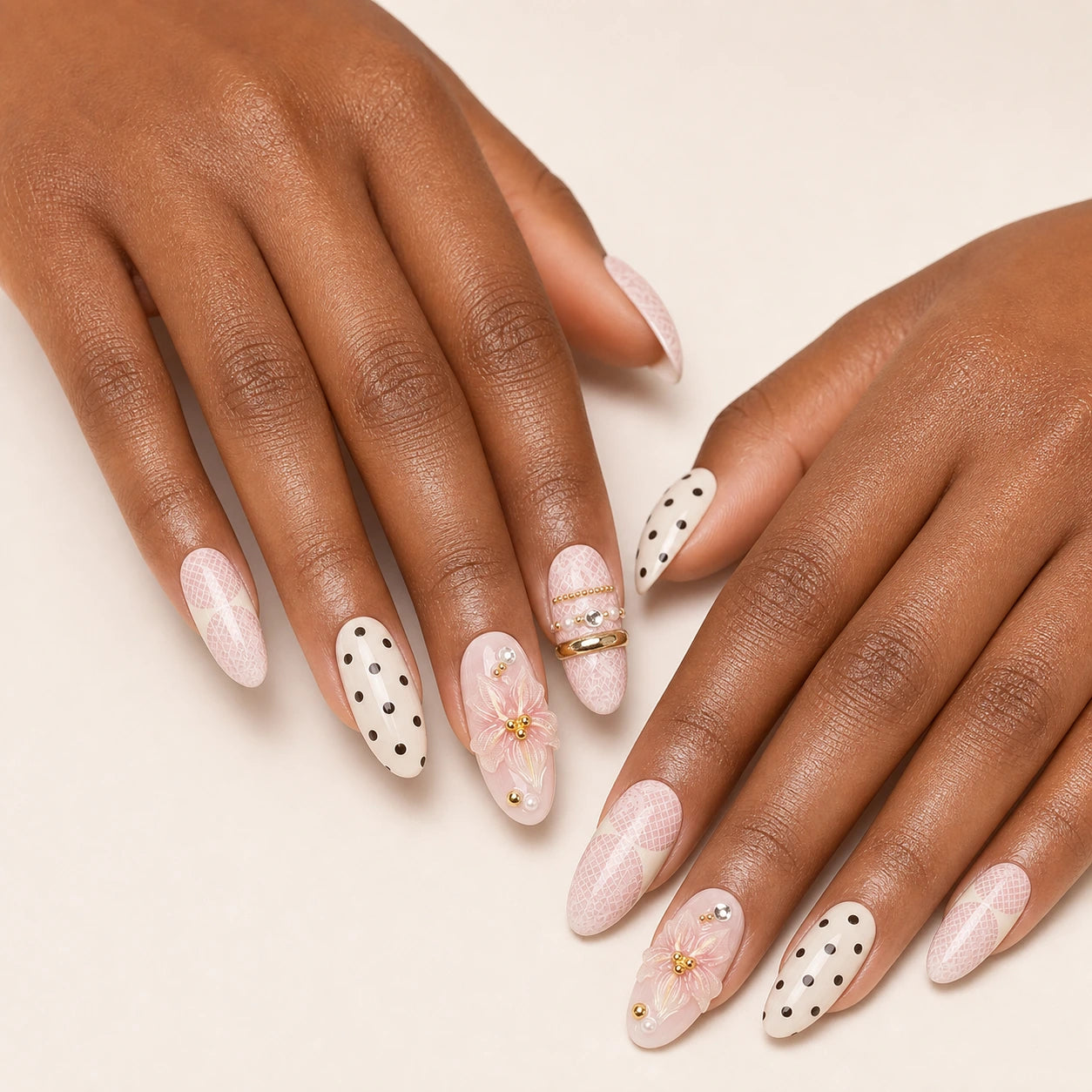 Lace Confetti blush polka dot manicure on two medium-brown hands