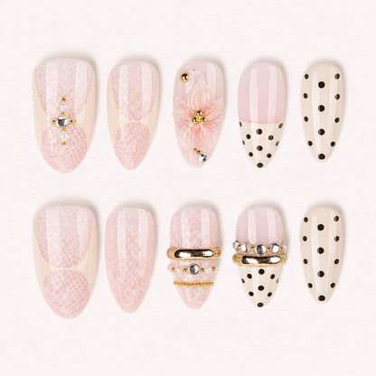 Lace Confetti pink ivory lace polka dot short almond press-on nails, ten-piece product display on pale warm background