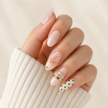 Lace Confetti pink ivory lace polka dot short almond press-on nails on one softly curled hand