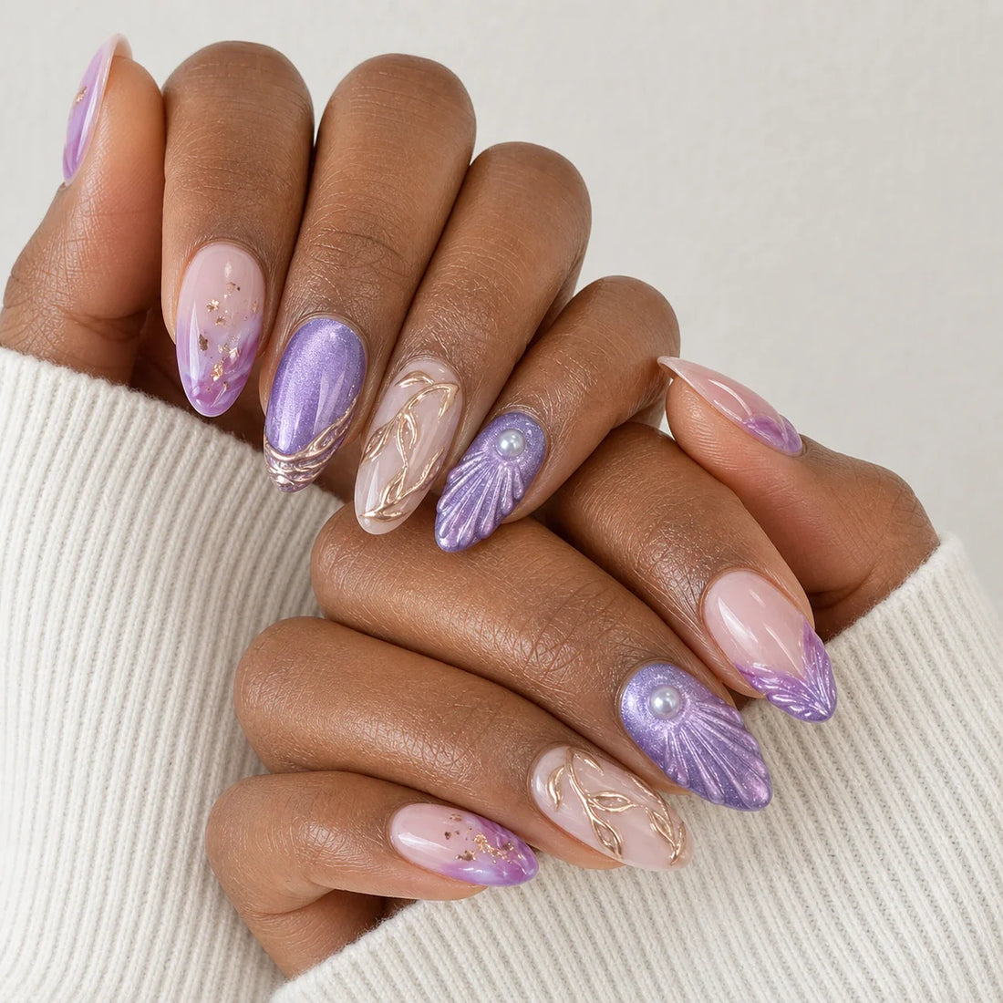 Lavender Grotto rose-gold shell manicure on two medium-brown hands