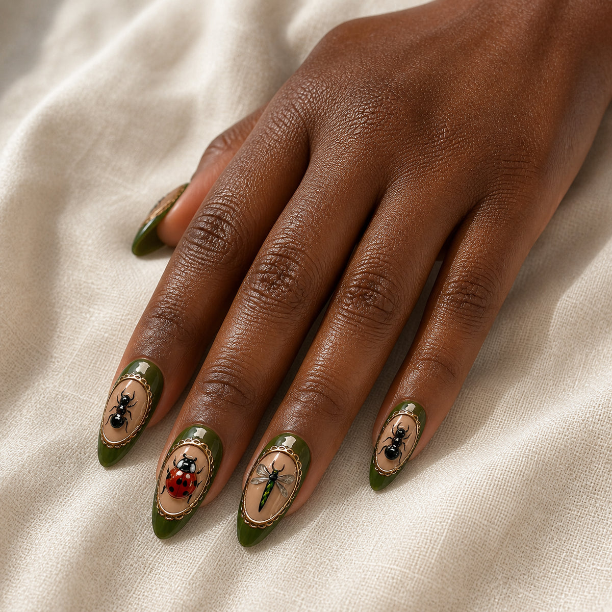 Beetle Cabinet press-on nails shown on dark-skinned one hand