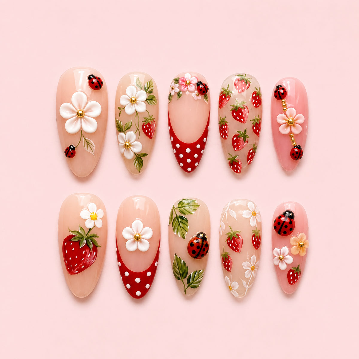 Berry Bug is a 24-piece handmade medium almond press-on nail set in soft pink, strawberry red, white and leaf green, featuring strawberries, daisies, ladybirds, polka dots and raised fruit-and-flower accents. It is designed as a reusable multi-size at-home manicure with no selectable size variant, flat lay