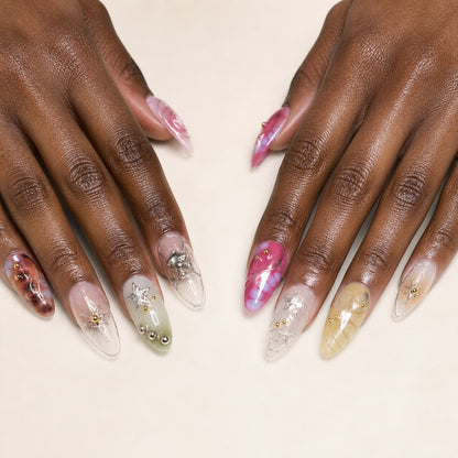 Cosmic Rosette press-on nails shown on dark-skinned two hands