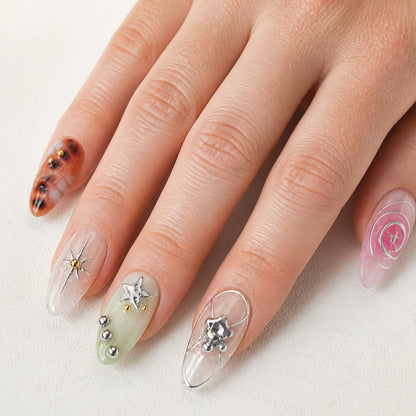 Cosmic Rosette press-on nails shown on light-skinned one hand