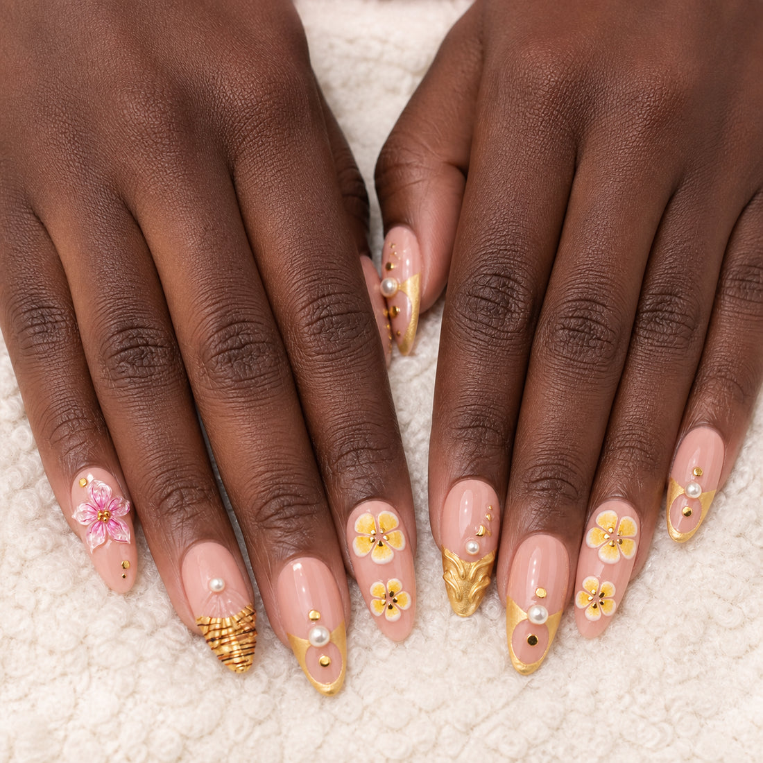 Gilded Hibiscus press-on nails shown on dark-skinned two hands